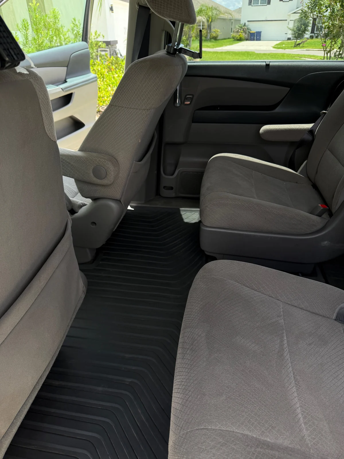 Honda Odyssey second-row floor and rubber mat after detailing, clean and cleared
