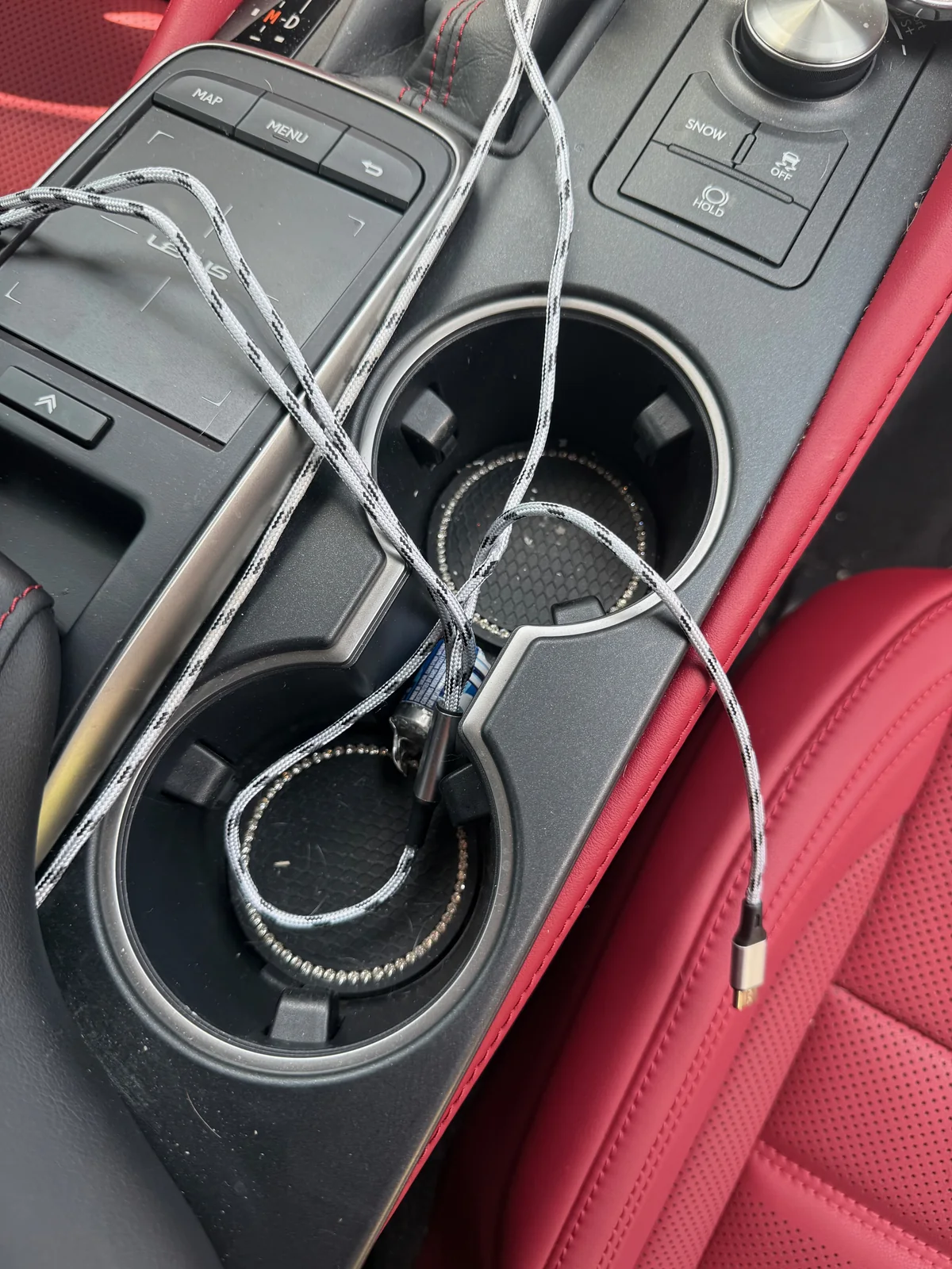Lexus RC 350 center console before detailing, with cables and dust in the cupholders